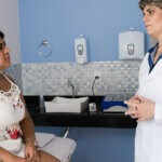 female doctor talking to a female patient