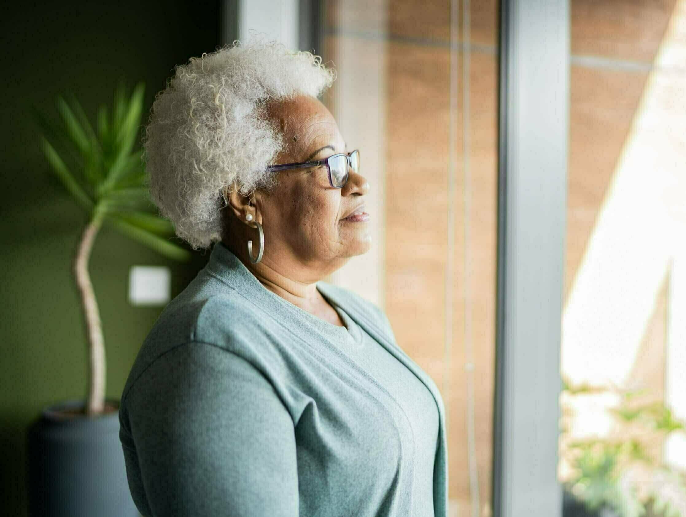 Senior woman contemplating at home Understand and prevent patient stereotype threat in healthcare